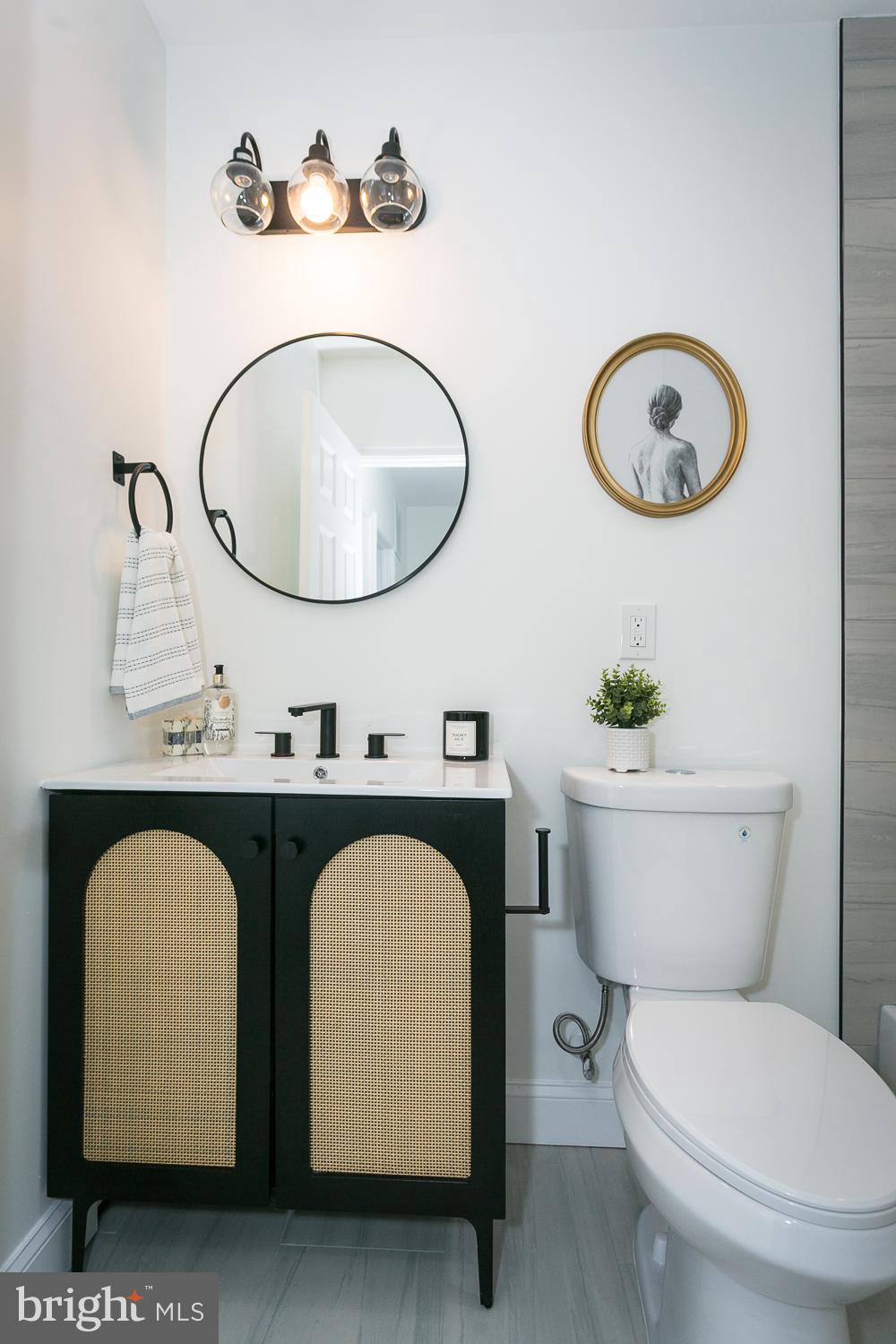 3729 Beehler Avenue Baltimore, MD 21215 - Photo 21 of 36 a bathroom with a toilet a sink and a mirror