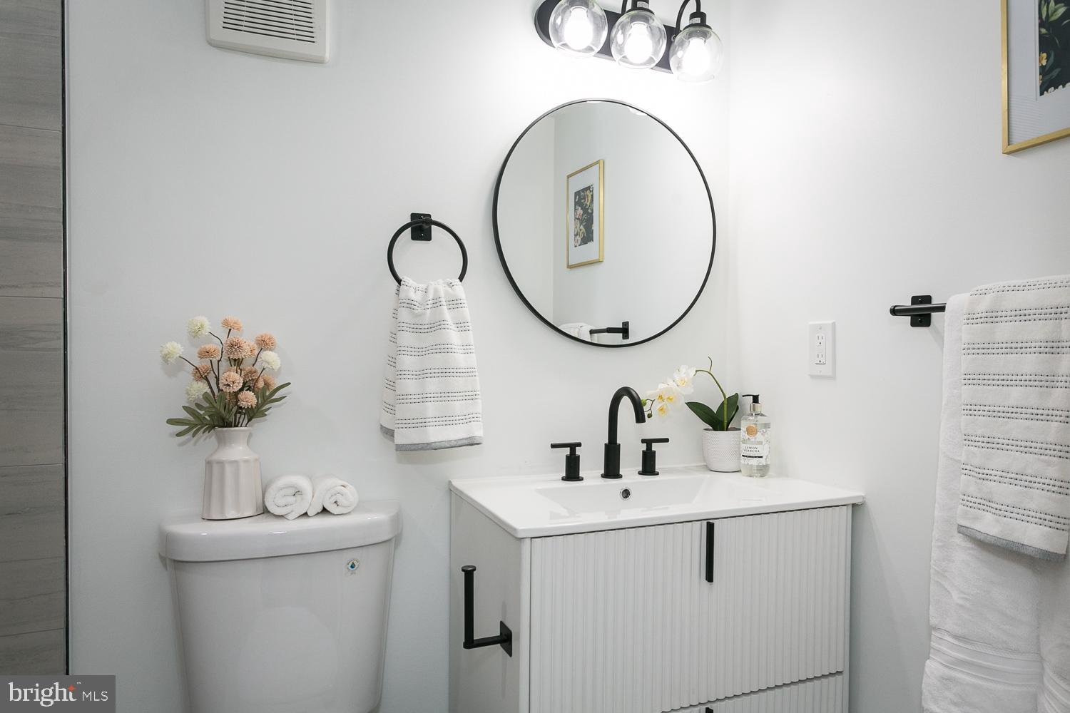 3729 Beehler Avenue Baltimore, MD 21215 - Photo 30 of 36 a bathroom with a sink and a mirror