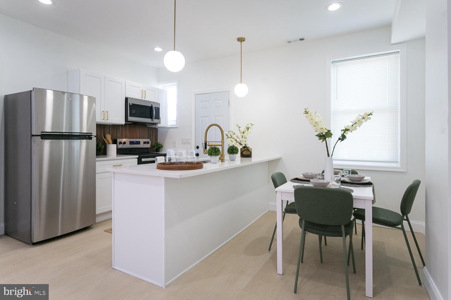 3729 Beehler Avenue Baltimore, MD 21215 - Photo 7 of 36 a kitchen with stainless steel appliances granite countertop a refrigerator a sink a stove a dining table and chairs