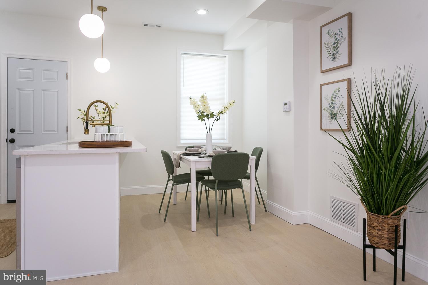 3729 Beehler Avenue Baltimore, MD 21215 - Photo 8 of 36 a dining room with furniture and a potted plant