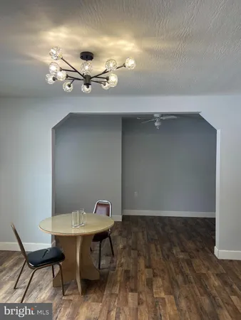 a view of a room with wooden floor and a sink