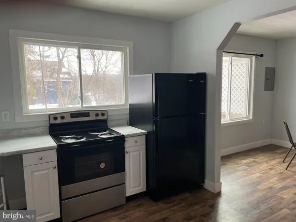 a kitchen with a stove and a refrigerator
