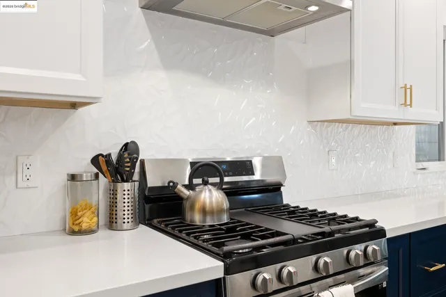 a stove top oven sitting inside of a kitchen