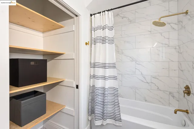 a bathroom with a shower and a sink