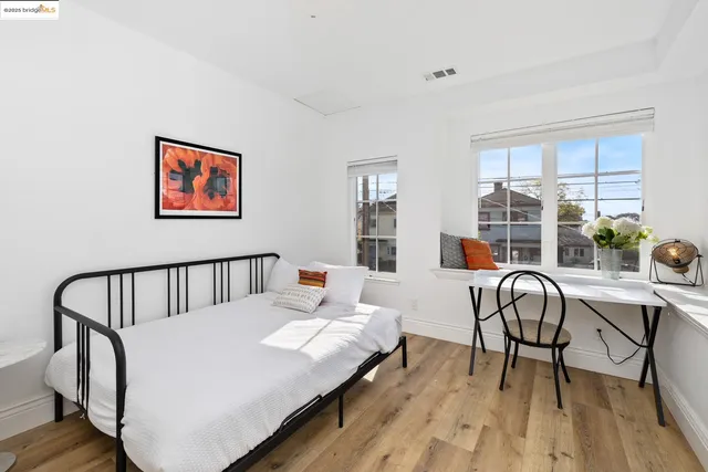 a bedroom with a bed and a large window