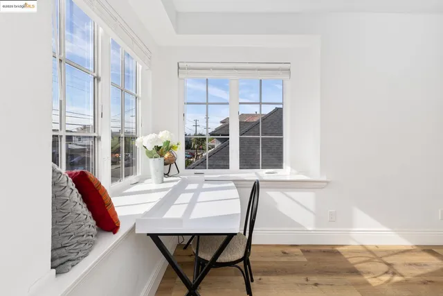 a dining room with furniture and a large window