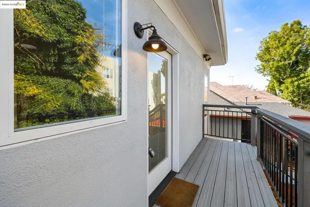 a view of a balcony with wooden floor and fence