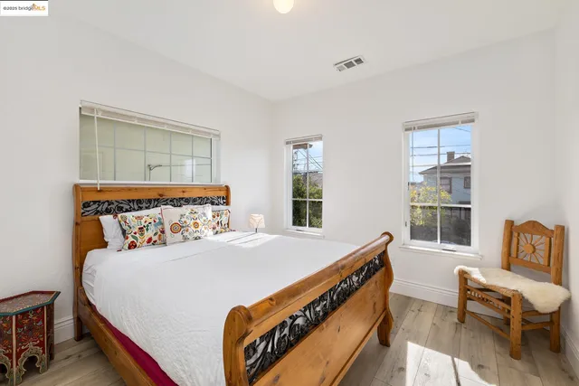 a bed sitting in a bedroom next to a window