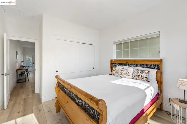 a bed sitting in a bedroom next to a window