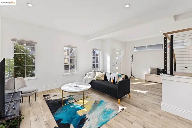 a living room with furniture a table and large window