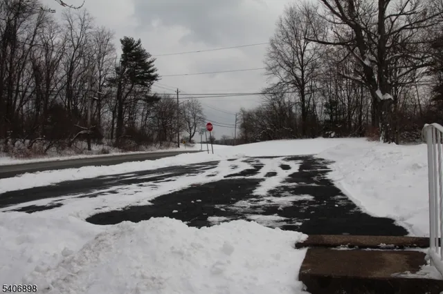 a view of house with a snow in the yard