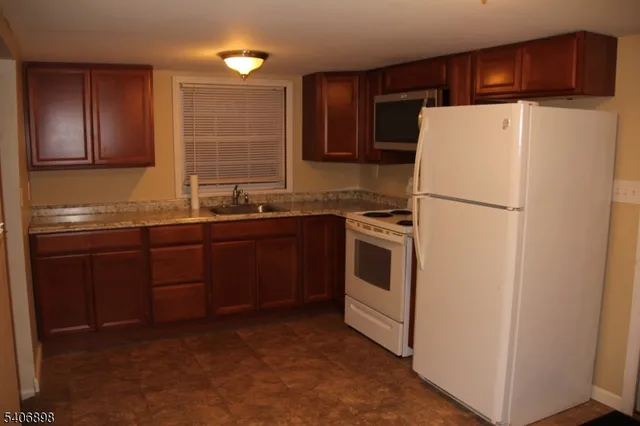 a white refrigerator freezer sitting in a kitchen
