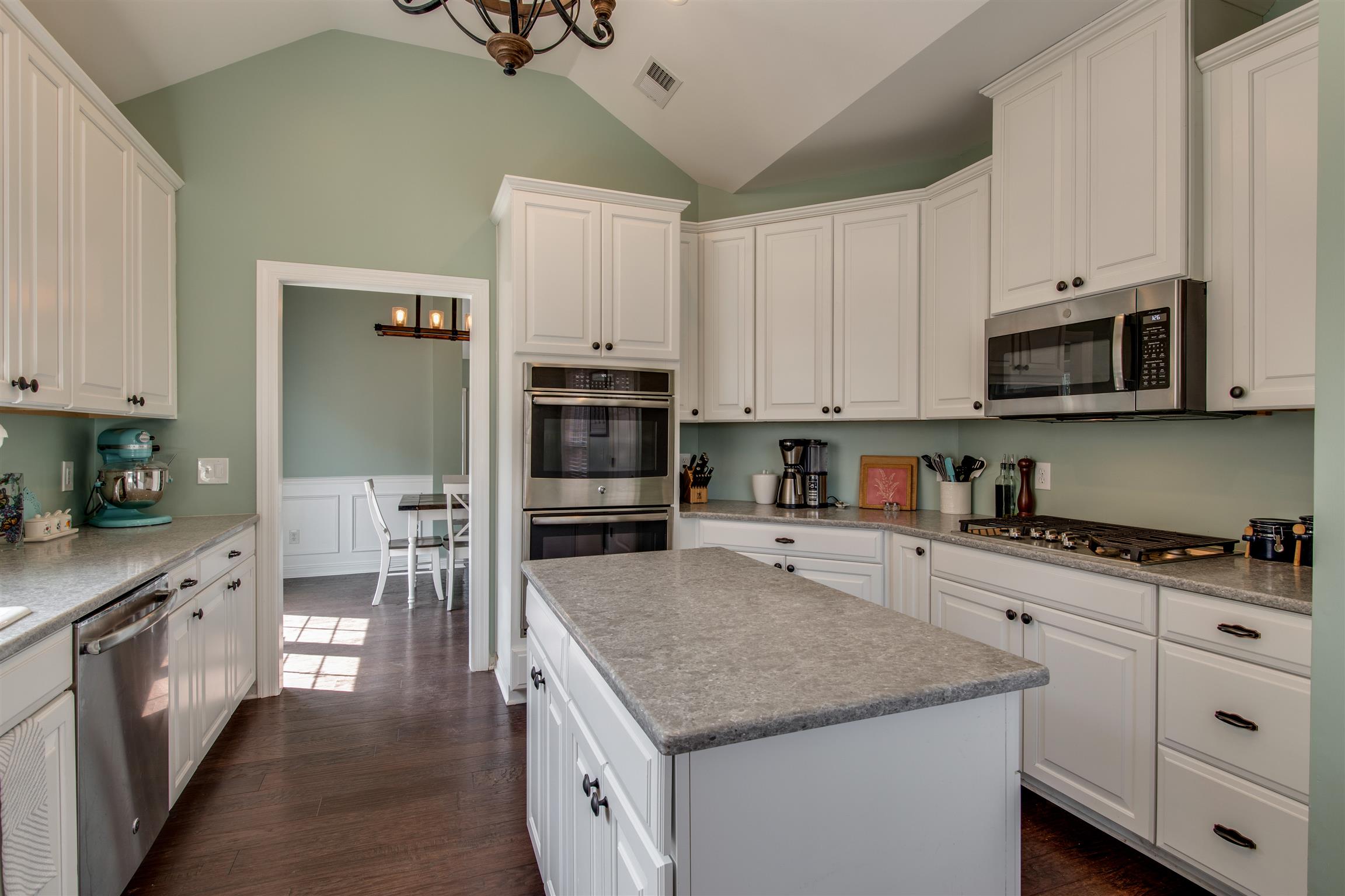 3181 Vera Valley Road Franklin, TN 37064 - Photo 12 of 26 a kitchen with stainless steel appliances granite countertop a stove top oven a sink and dishwasher with white cabinets