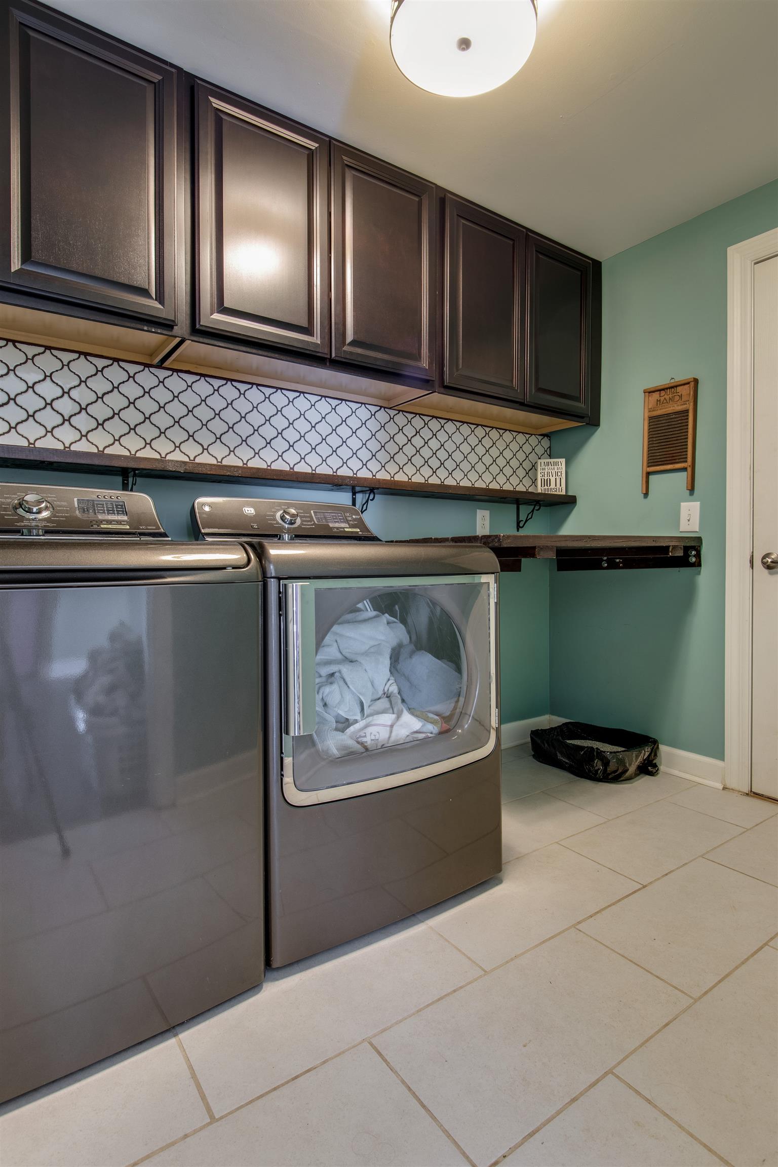 3181 Vera Valley Road Franklin, TN 37064 - Photo 14 of 26 a kitchen with a wooden floor and cabinets