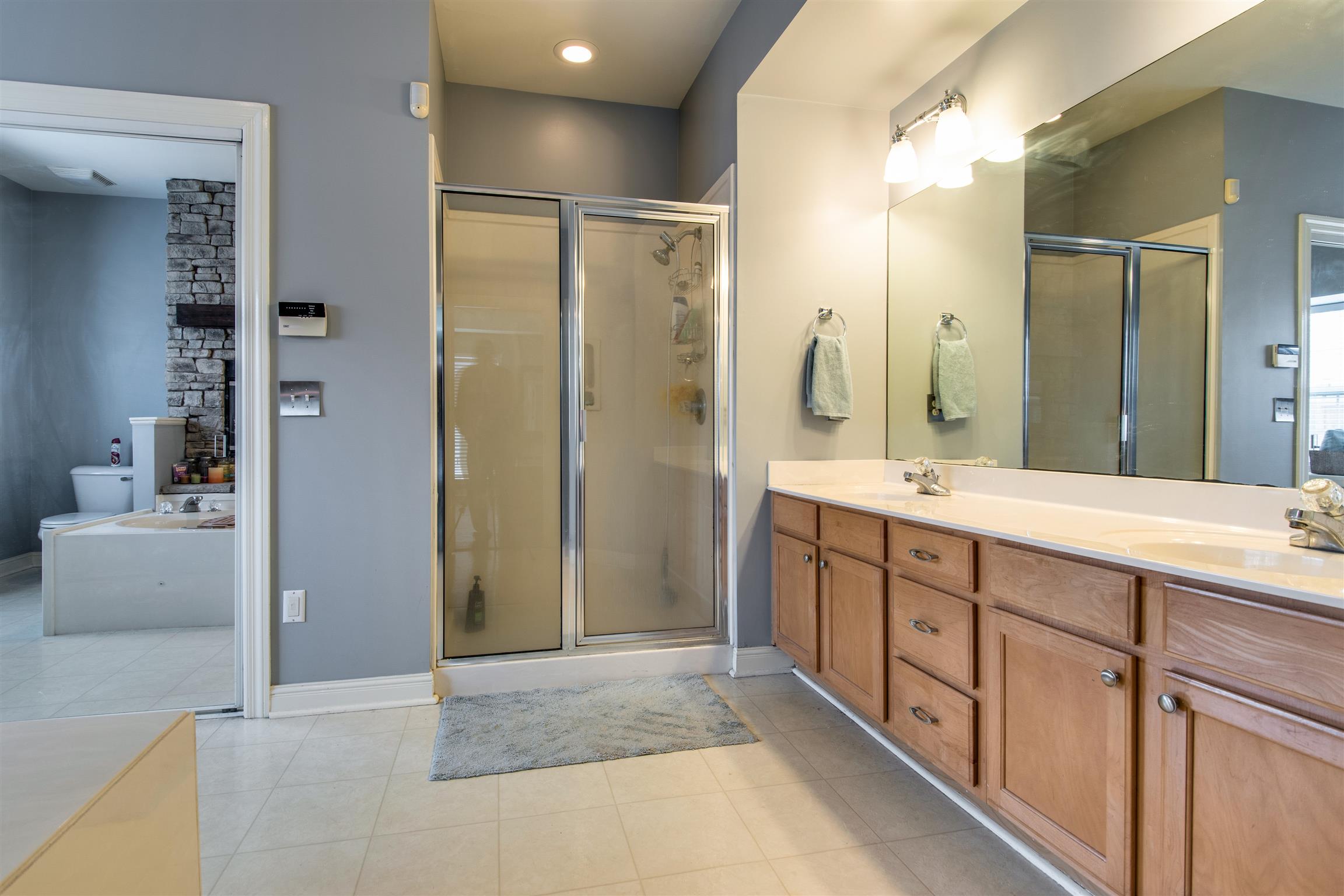 3181 Vera Valley Road Franklin, TN 37064 - Photo 17 of 26 a spacious bathroom with sinks shower and a mirror