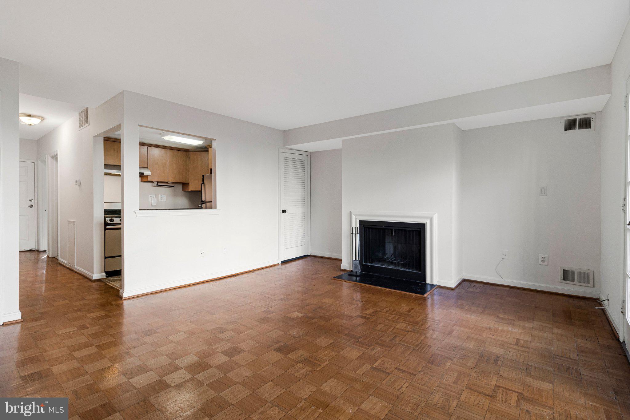 1248 C Street Southeast, Unit A Washington, DC 20003 - Photo 5 of 15 a view of an empty room with a fireplace