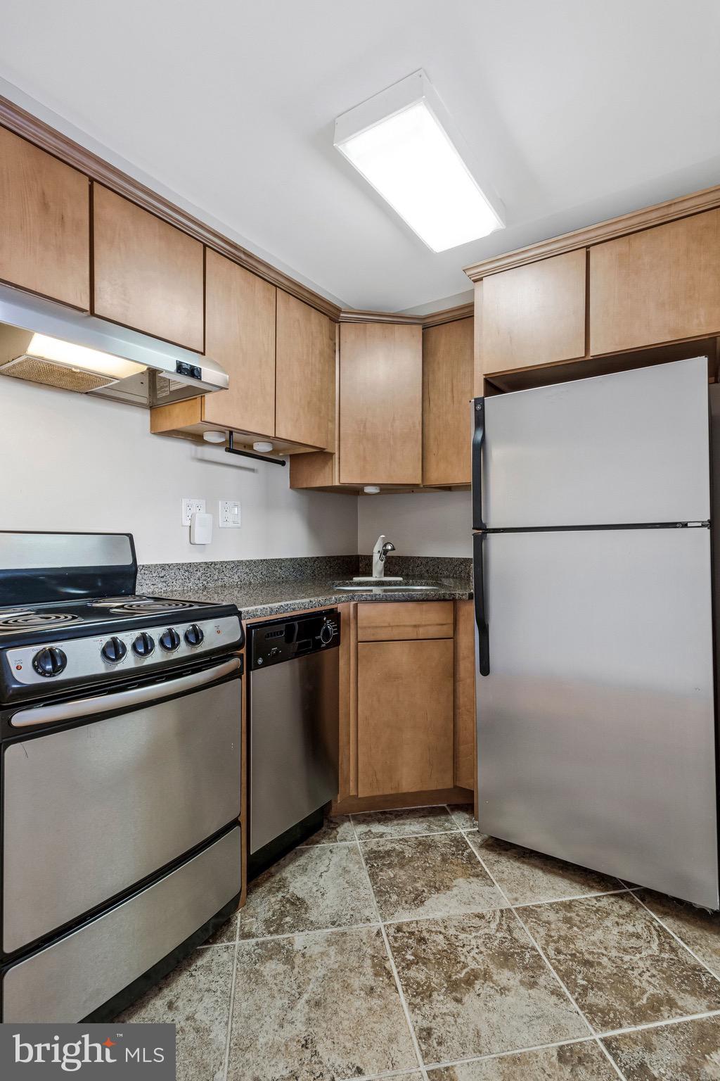 1248 C Street Southeast, Unit A Washington, DC 20003 - Photo 7 of 15 a kitchen with stainless steel appliances granite countertop a refrigerator sink and stove