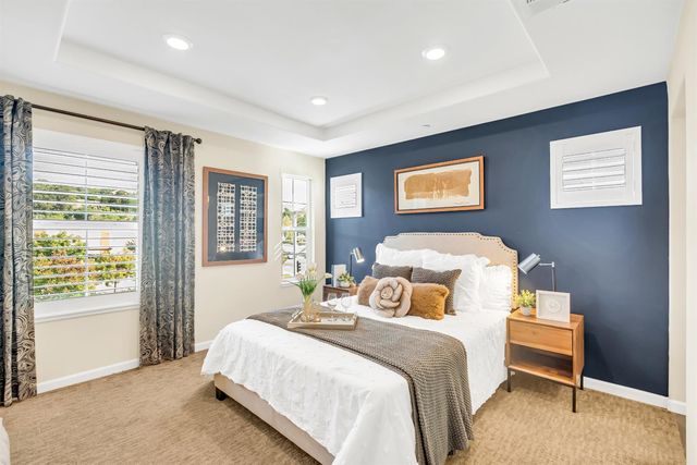 a bedroom with a bed and glass windows