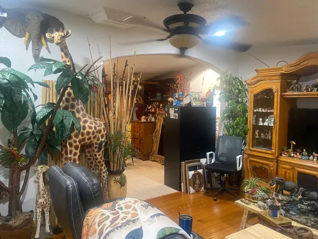 a living room with patio furniture and a flat screen tv