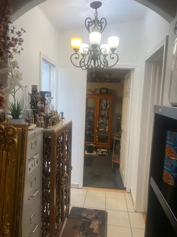 a living room with furniture and a book shelf