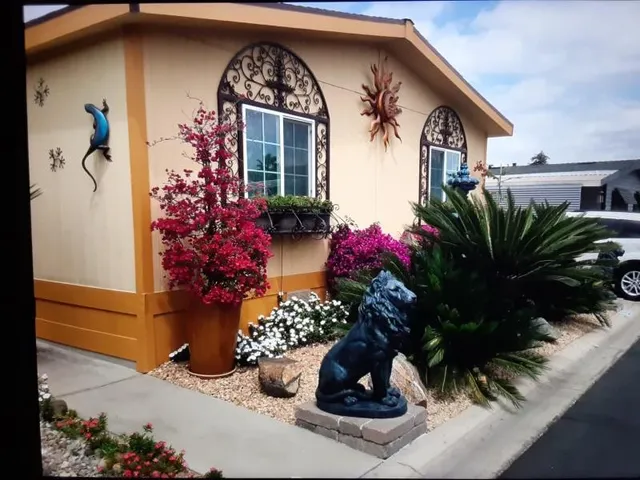 a view of a house with a flower garden