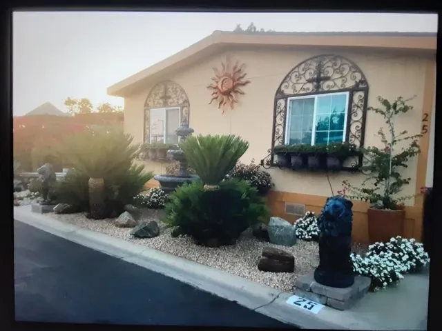 a front view of a house with garden