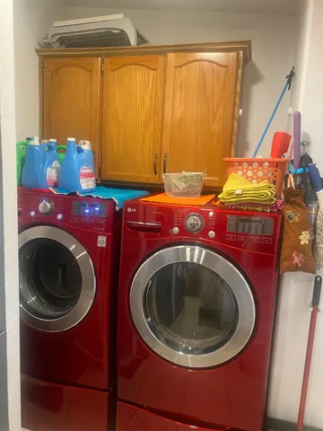 a utility room with sink dryer and washer