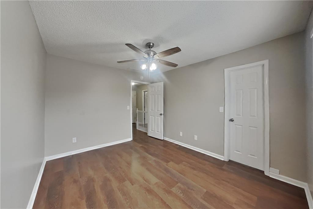 1603 Fort Perry Way Dacula, GA 30019 - Photo 12 of 19 a view of an empty room with a ceiling fan