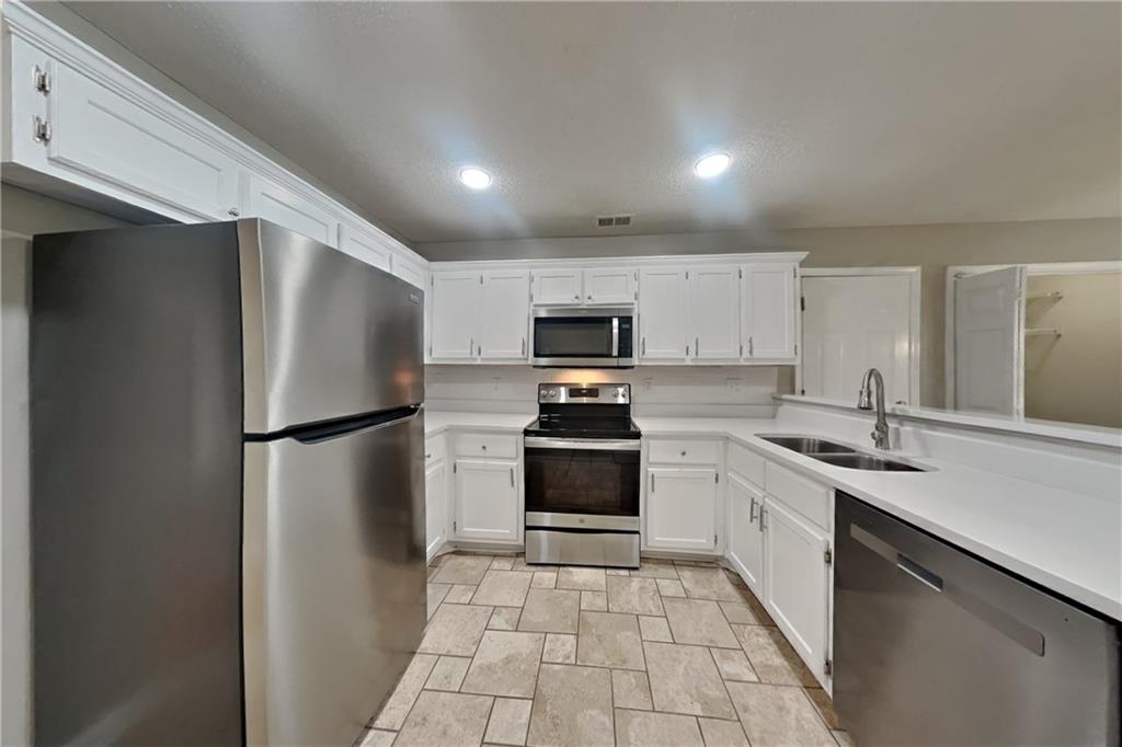 1603 Fort Perry Way Dacula, GA 30019 - Photo 4 of 19 a kitchen with a refrigerator sink and microwave
