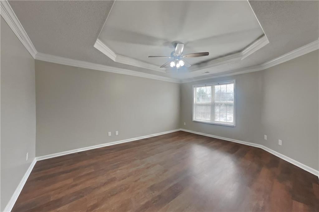 1603 Fort Perry Way Dacula, GA 30019 - Photo 7 of 19 an empty room with wooden floor and windows