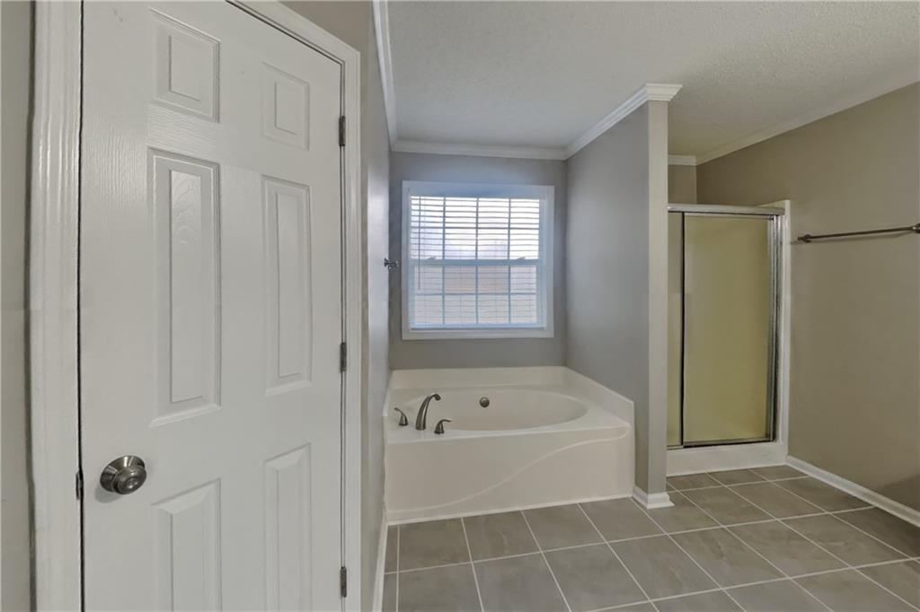 1603 Fort Perry Way Dacula, GA 30019 - Photo 10 of 19 a white bath tub sitting next to a window