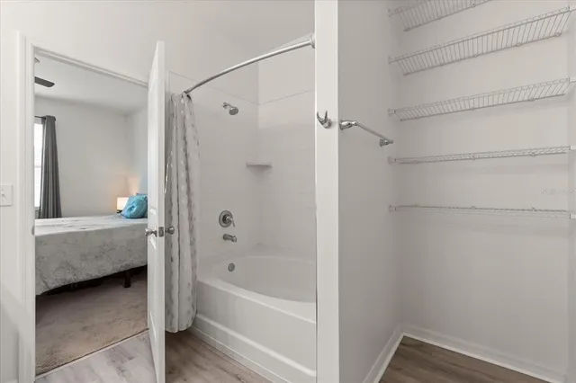 a bathroom with a tub shower and a sink