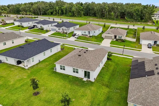 an aerial view of a house with swimming pool garden and patio