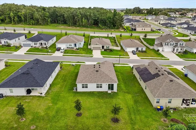 an aerial view of a house with pool