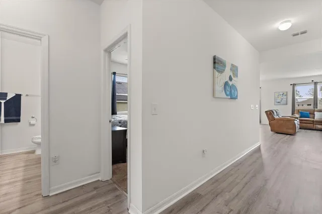 a hallway with wooden floor and furniture