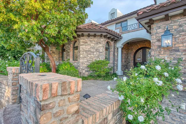 a front view of a house with garden
