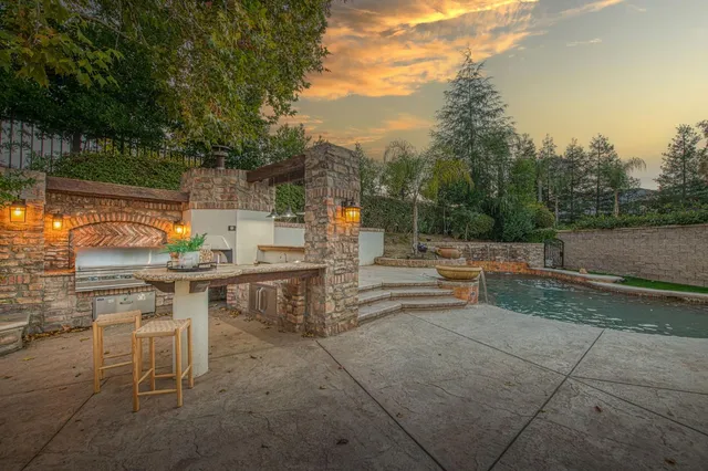 a backyard of a house with table and chairs