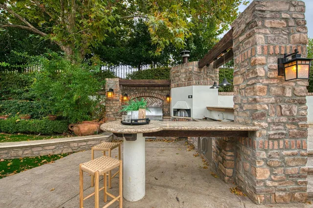 a view of a patio with table and chairs and potted plants