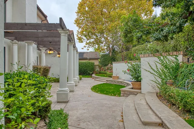 a view of a house with potted plants