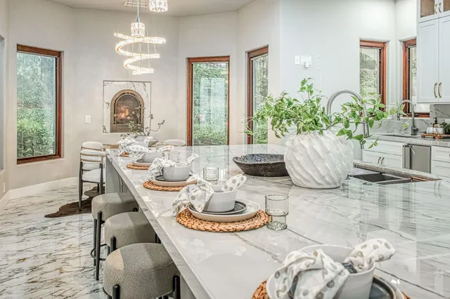 a dining room with furniture a large window and wooden floor