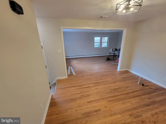 a view of a livingroom with wooden floor and window