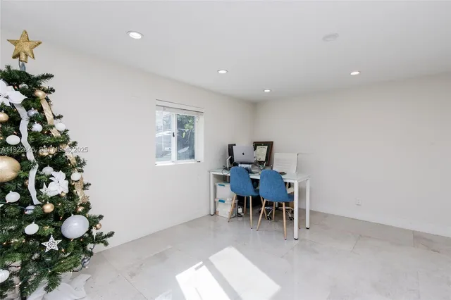 a view of a dining room with furniture and a potted plant
