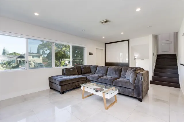 a living room with furniture and a large window