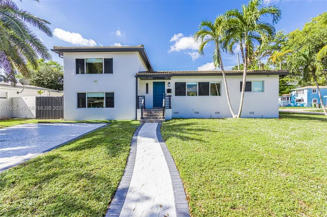 a front view of a house with garden