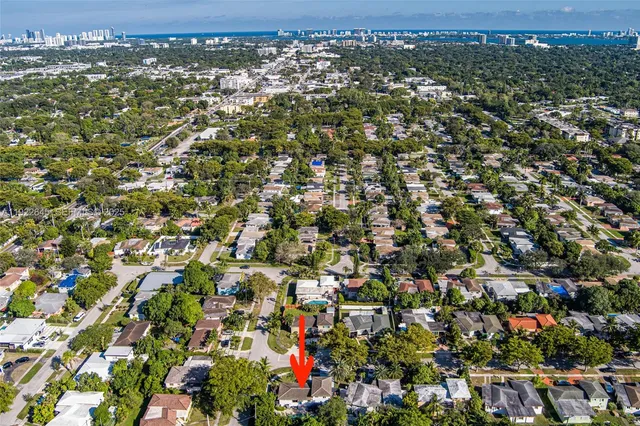 an aerial view of residential houses with city view