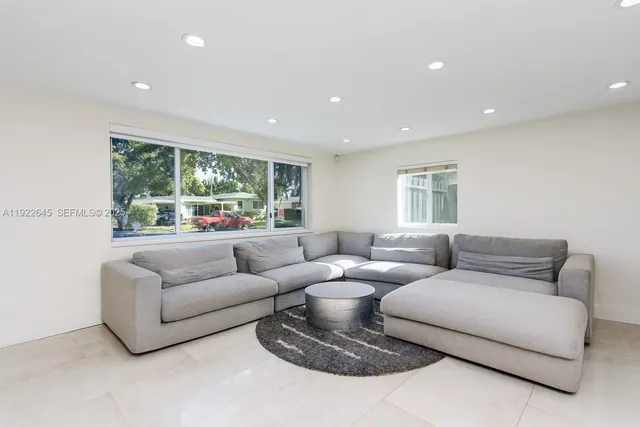 a living room with furniture and a large window