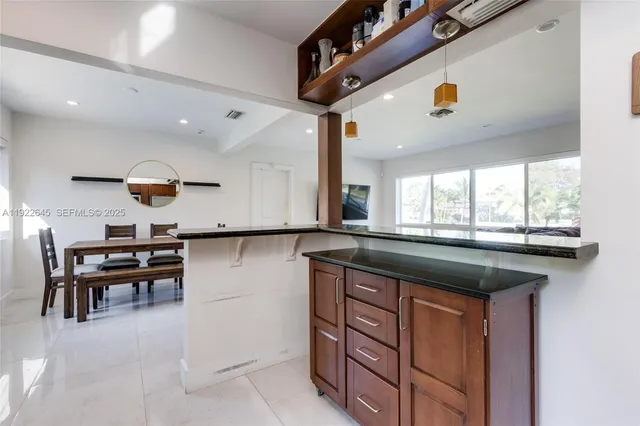 a kitchen with stainless steel appliances granite countertop a stove and cabinets