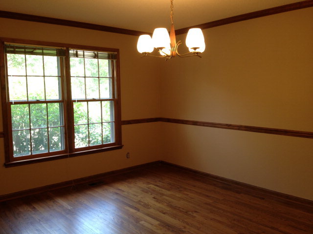 6310 Stapleton Road Macon, GA 31206 - Photo 5 of 15 a view of an empty room with wooden floor and a window
