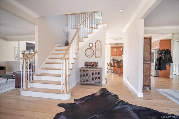 a view of entryway and hall with wooden floor