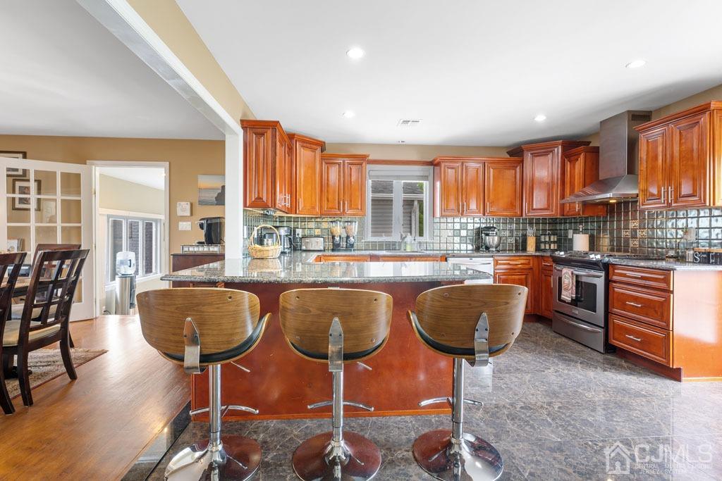 713 New Dover Road Edison, NJ 08820 - Photo 13 of 46 a kitchen with granite countertop a stove a table and chairs